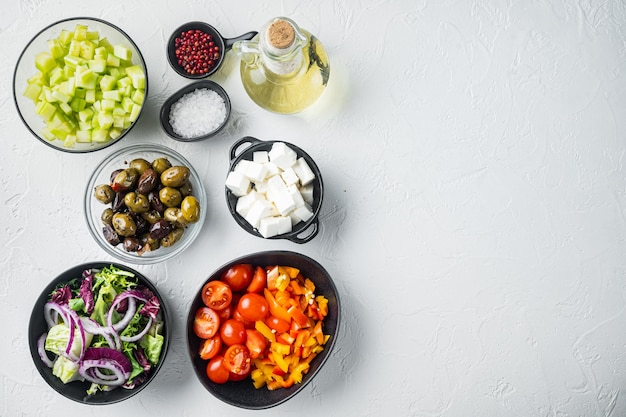 Photo ingredients for greek salad, on white background, top view flat lay  with copy space for text