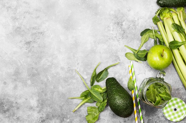 Ingredients for green smoothie - apples, spinach, celery, avocado on a light background. Top view, copy space. Food background.