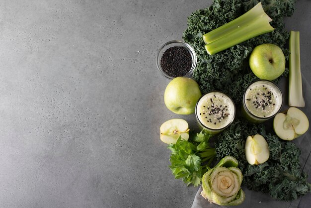 Ingredients for a green smoothie on a gray table