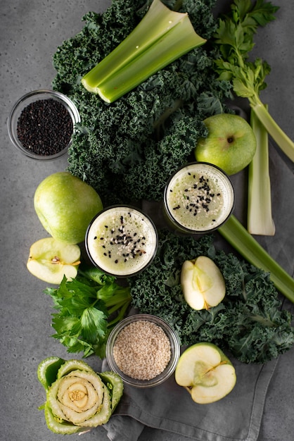 Ingredients for a green smoothie on a gray table
