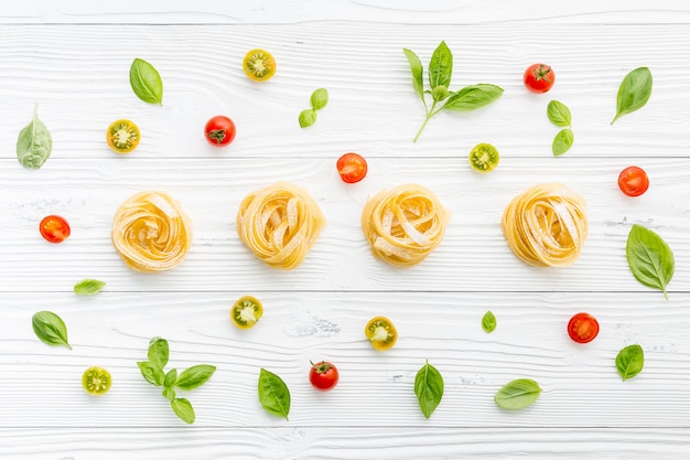 Ingredients for homemade pasta on wooden background.