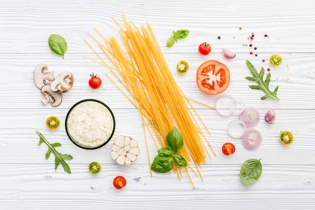 Ingredients for homemade pasta on wooden background.