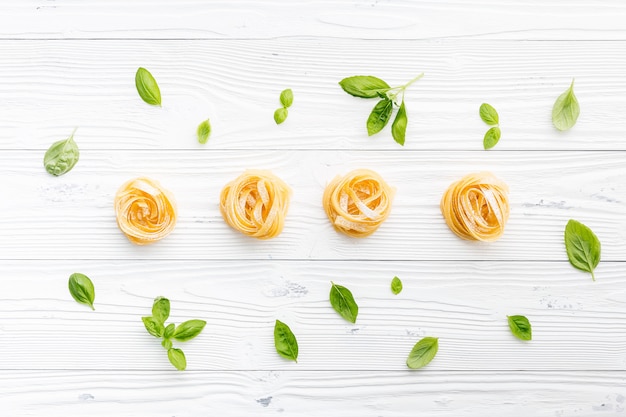 Ingredients for homemade pasta on wooden background.