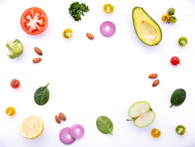 The ingredients for homemade pesto sauce basil parmesan cheese garlic olive oil lemon pine nut pepper corn and himalayan salt on dark stone background with flat lay and copy space