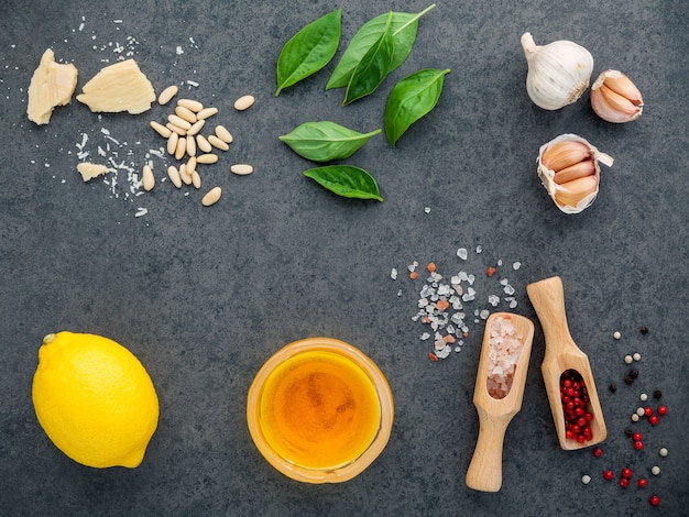 The ingredients for homemade pesto sauce  on dark stone background .