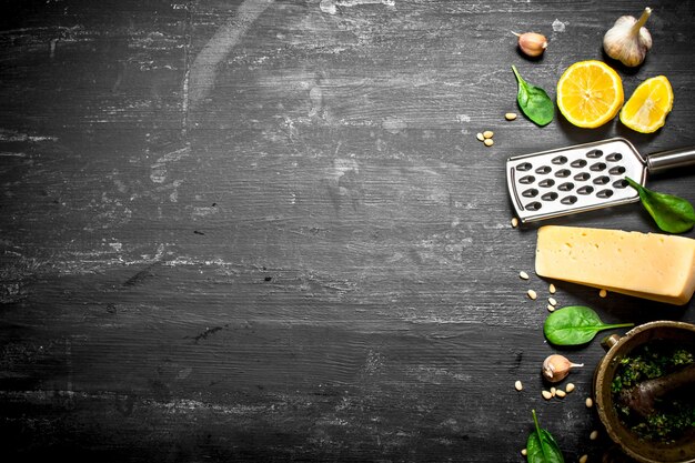 Ingredients for Italian pesto. On the black wooden table.