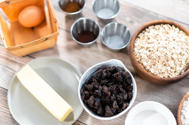 Ingredients to make chewy oatmeal raisin cookies.