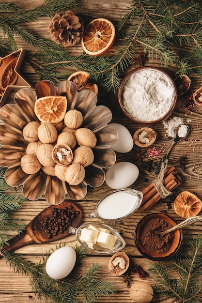 Ingredients for making christmas cupcake on wooden board