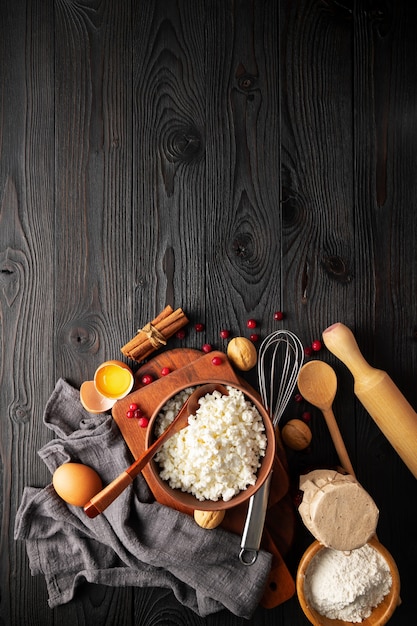 Ingredients for making curd casserole on wooden background, top view, copy space