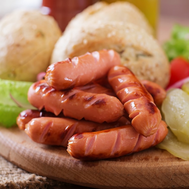 Ingredients for making Hot dog - sandwich with pickles, red onions and lettuce on wooden background