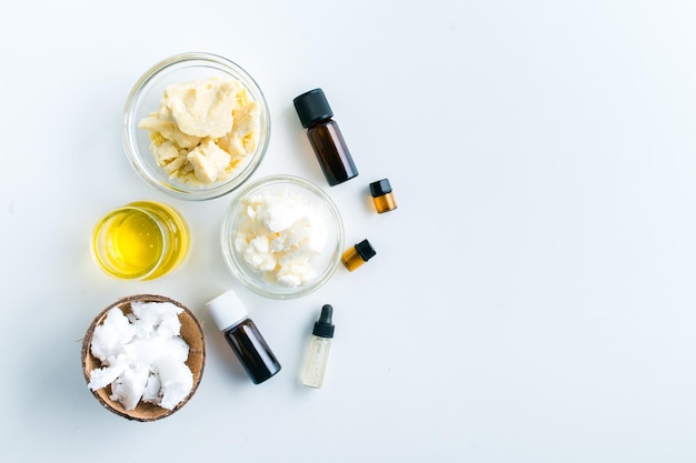 ingredients for making moisturizing body butter at home on white background with copy space