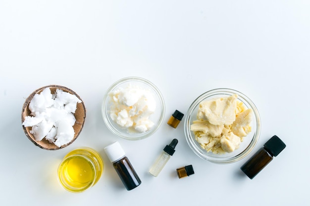 ingredients for making moisturizing body butter at home on white background with copy space