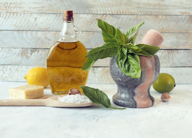 Ingredients for making pesto sauce basil leaves olive oil garlic salt cheese and citruses