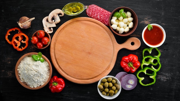 Ingredients for making pizza On a wooden background Top view Free space for your text