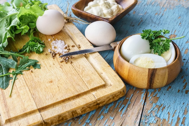 Ingredients for making salad on a cutting board on a rustic table