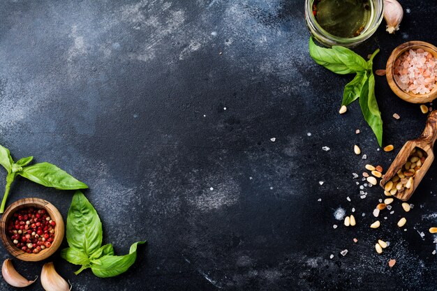 Ingredients for making traditional italian pesto sauce on old background. Flat lay.