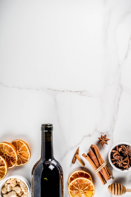 Ingredients for mulled wine cocktail with wine bottle and spices