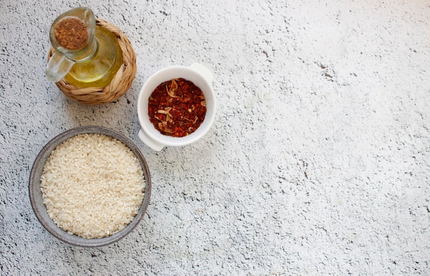 Ingredients for paella grey bowl with rice on background with\
copy space for your text top view natural food high in protein