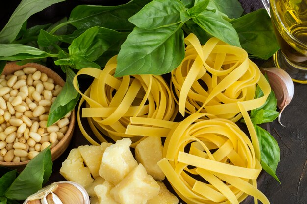 Ingredients for pesto pasta on black