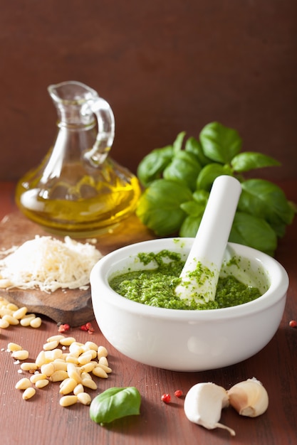 Ingredients and pesto sauce over wooden rustic table