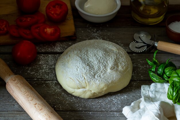 Ingredients for pizza. Dough, tomatoes, mozzarella, basil. Italian cuisine.