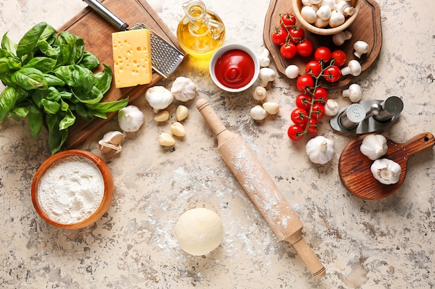 Ingredients for pizza on light surface