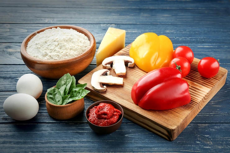 Photo ingredients for pizza on wooden background