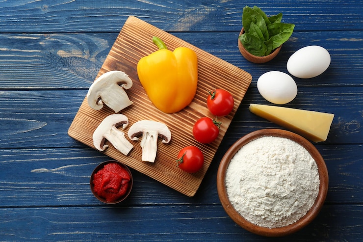 Photo ingredients for pizza on wooden background