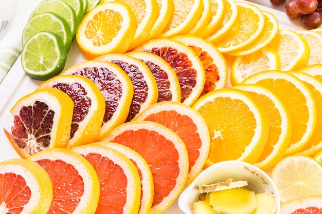 Ingredients for preparing detox citrus infused water as a refreshing summer drink.