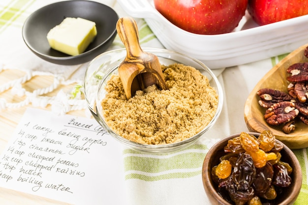 Ingredients for preparing homemade baked apples from organic apples.