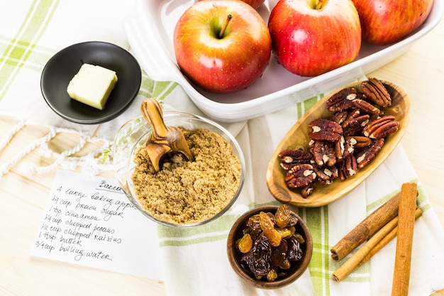 Ingredients for preparing homemade baked apples from organic apples.