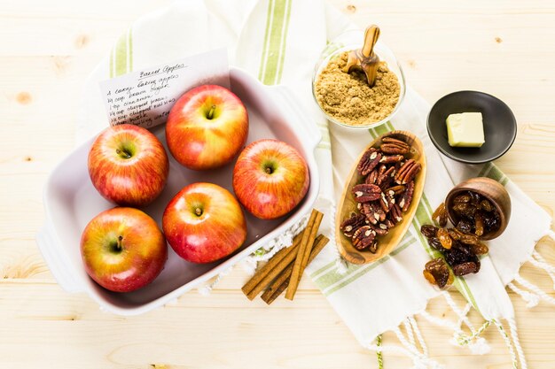 Ingredients for preparing homemade baked apples from organic apples.