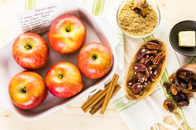 Ingredients for preparing homemade baked apples from organic apples.