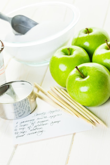 Ingredients for preparing homemade black candy apples.
