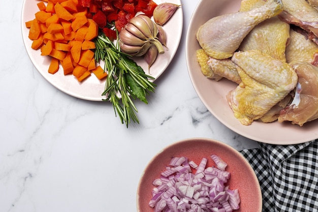 Ingredienti per la ricetta del pollo allo stufato di birra cruda. pollo, cipolla, carote, aglio, peperoncino ed erbe aromatiche