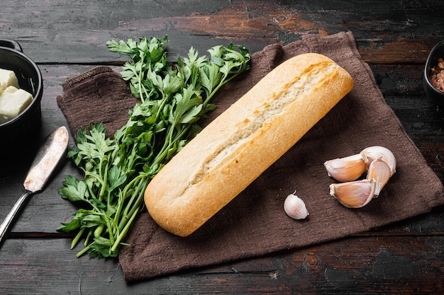 Ingredients for sandwich with butter, herbs and baguette set, on old dark  wooden table background