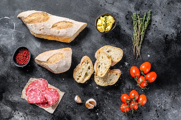 Ingredients for sandwich with butter smoked meat baguette cherry tomatoes parmesan cheese