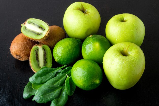 Ingredients for smoothie, Green fruits on black wooden surface