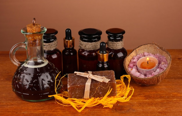 Photo ingredients for soap making on brown background