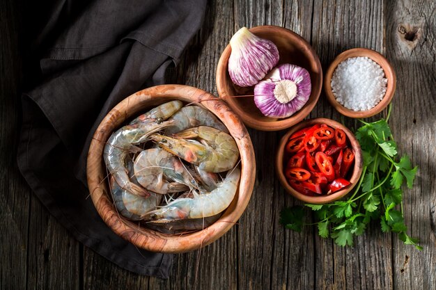 Ingredients for tasty and sweet shrimp on wooden bowl