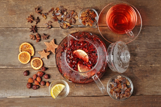 Ingredients for tea drinking on wooden background flat lay