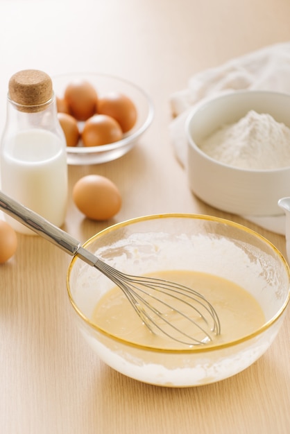 Ingredients and tools for baking sweet cake with banana and almonds