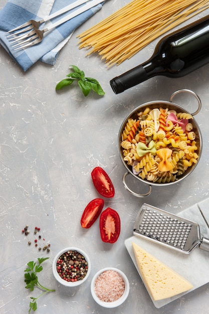 Ingredients for traditional pasta cooking - cheese, tomatoes, condiments. 