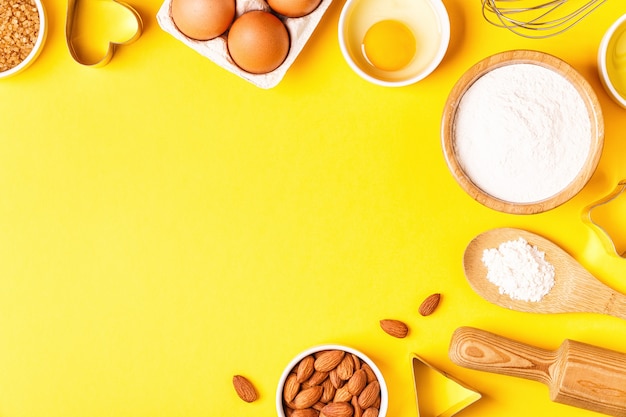 Ingredients and utensils for baking on a pastel background, top view.