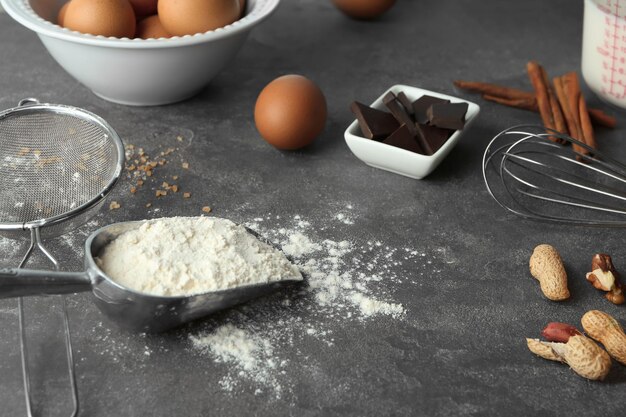 Ingredients and utensils for cooking pastries on grey background