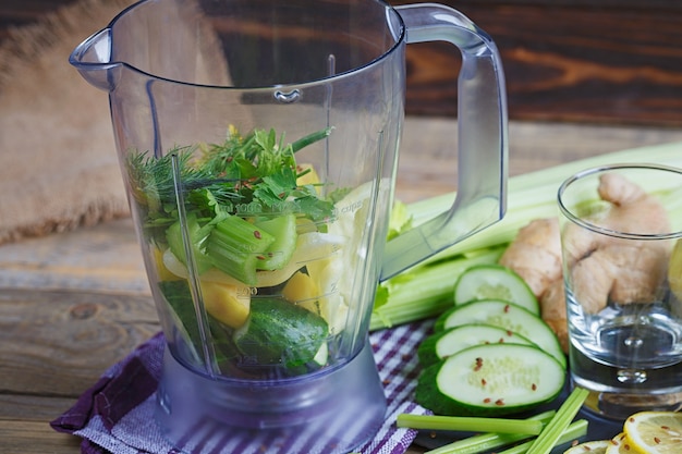 Ingredients for vegetables smoothie on wooden surface