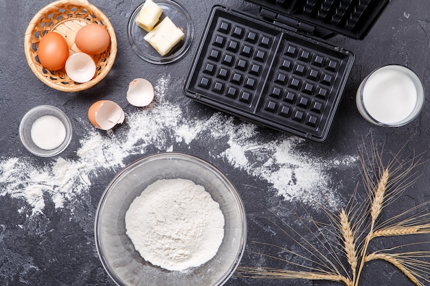 Ingredients for waffles on black table