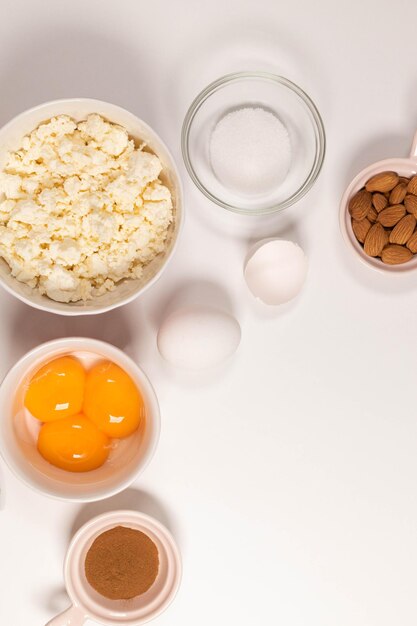 Ingredients for winter festive baking - flour, sugar, eggs, butter on white background.Top view copy space.