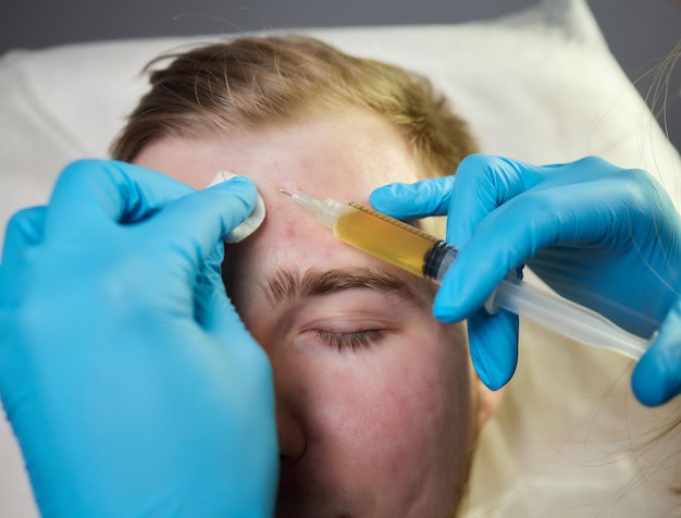 Injection at spa salon doctor hands in gloves closeup pretty male patient beauty treatment healthy s