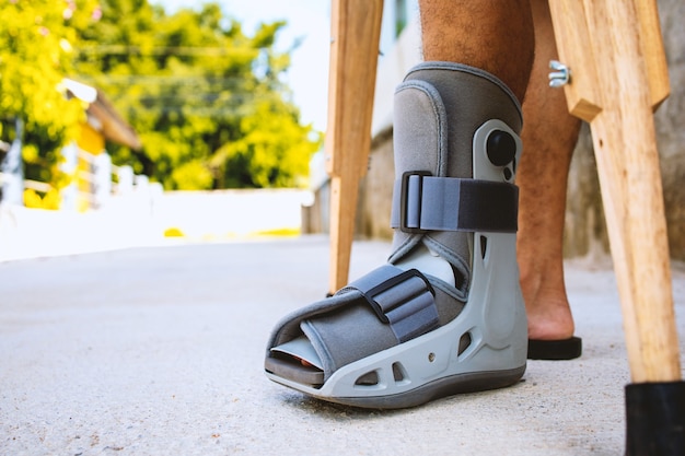 Injured man broken ankle wearing ankle support